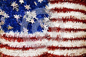 Tinsel and cellophane American flag with sparkly stars background