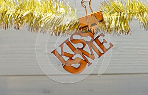 Tinsel with christmas ornaments and blank paper note wooden background. Merry christmas and love concept. Christmas