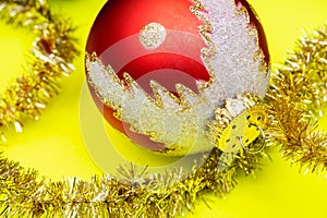 Tinsel Garland and Vintage Christmas Tree Ball isolated on bright yellow background. Winter Holidays Decoration