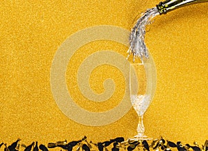 Tinsel pouring to glass of Champagne