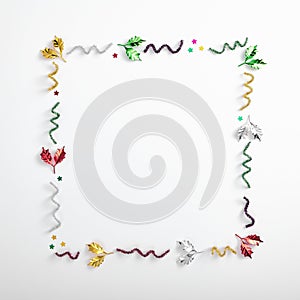 Tinsel on white background. Party pattern with glitter, stars and tinsel. Copy space with party elements. Tinsel for christmas