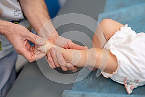 Tiny baby leg massaging. Feet massage making for child.