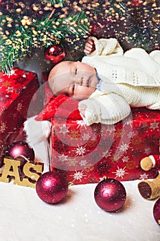 Tiny Baby Lying On A Christmas Gift Box