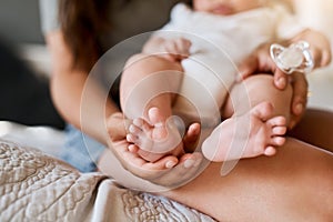 Tiny baby toes are the cutest thing in the world. a mother holding her babys feet.