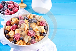 Tiny breakfast croissant cereals with fresh berries and milk