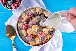 Tiny breakfast croissant cereals with fresh berries and milk
