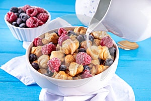 Tiny breakfast croissant cereals with fresh berries and milk