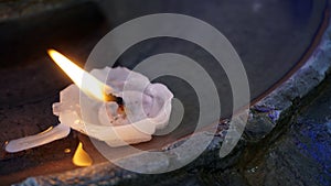 Tiny candle floating in a fountain