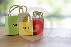 Tiny colored shopping bags with SALE text, annual sale
