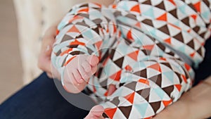 Tiny cute newborn baby foot in female hands