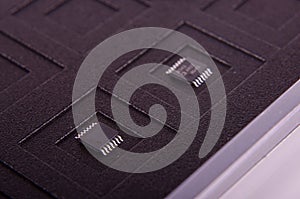 Tiny electronics chip component on the black antistatic mat