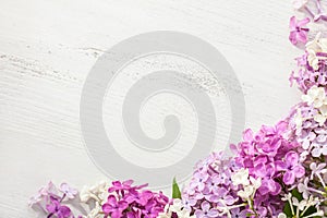 Tiny flowers of Lilac on an old wooden background. Floral border photo