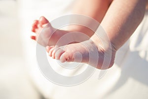 Tiny foot of newborn baby in soft selective focus