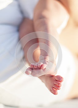 Tiny foot of newborn baby in soft selective focus