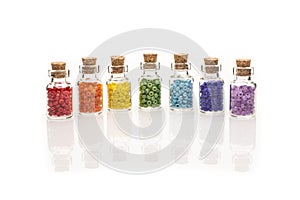 Tiny glass bottles filled with colourful beads