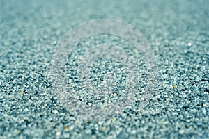 Tiny gravel texture on blue light concrete wall. Texture background seamless gravel floor