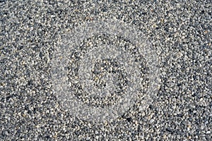 Tiny gravel texture on grey concrete wall. Texture background seamless gravel floor