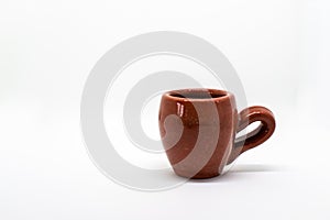 Tiny iconic brown hot chocolate mug isolated on a white background