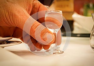Tiny liqueur glass in hand photo