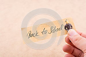Tiny man figurine and back to school title