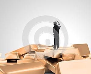 Tiny man with a pickaxe on top of a pile of gold photo
