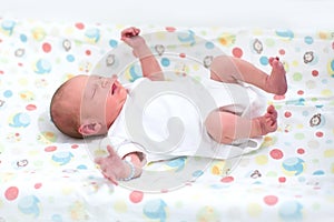 Tiny newborn baby on a changing table