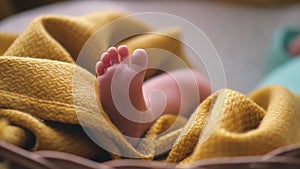 Tiny newborn baby's feet closeup. Mom and her child. Happy family concept. Beautiful conceptual video of maternity.