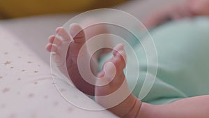 Tiny newborn baby's feet closeup. Mom and her child. Happy family concept. Beautiful conceptual video of maternity.