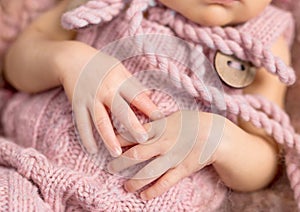 Tiny newborn child hands, close up
