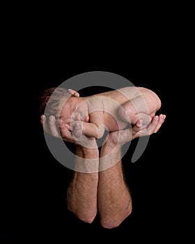 Tiny newborn in Father's Hands