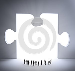 Tiny people and a jigsaw puzzle piece