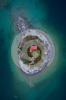 Tiny red house on a island