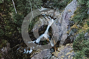 Tiny river between the rocks in the forest