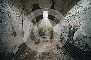 Tiny stool in an abandoned prison cell