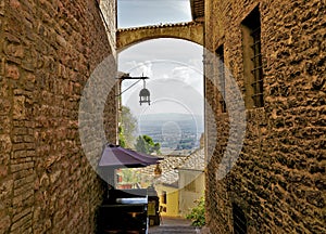 A tiny street in the city Assisi , Italy.