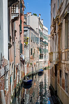 Tiny Venice old town channel with beautiful reflections on the water