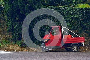 Tiny vintage, oldschool car in green vivid background, typical italian colors