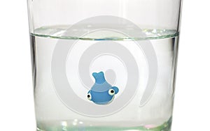 Tiny whale swimming in glass of water