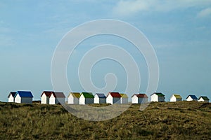 The tiny white beach cottages with colorful roofs