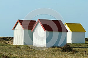 The tiny white beach cottages with colorful roofs