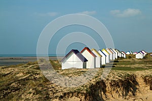 The tiny white beach cottages with colorful roofs