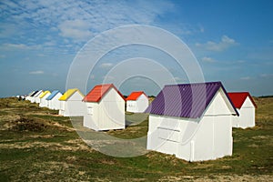 The tiny white beach cottages with colorful roofs