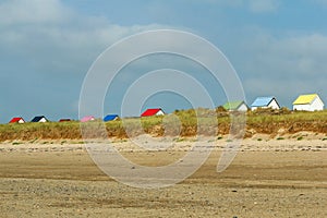 The tiny white beach cottages with colorful roofs