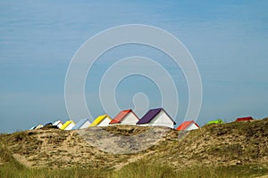 The tiny white beach cottages with colorful roofs