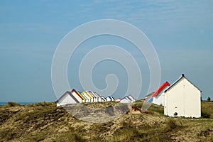 The tiny white beach cottages with colorful roofs