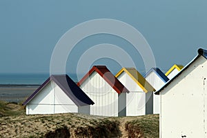 The tiny white beach cottages with colorful roofs