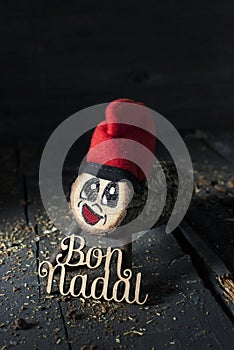 Tio de nadal and text merry christmas in catalan photo