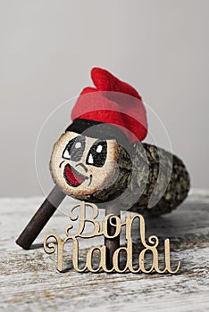 Tio de nadal and text merry christmas in catalan photo