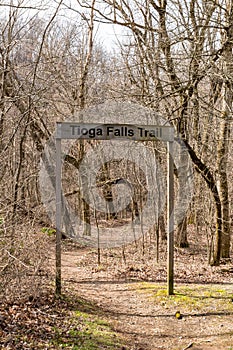 The Tioga Falls Trail sign at the entrance to the trail in the woods at the Bridges to the Past area