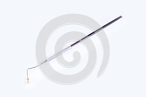 Tip of dental probe on real human extracted tooth photo